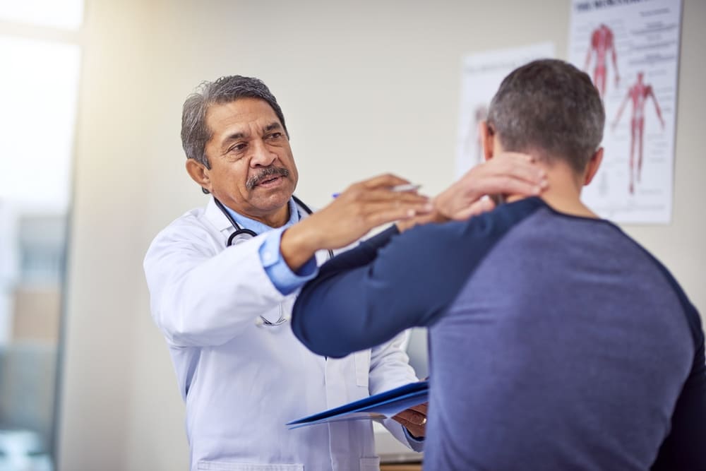 doctor treating patient with whiplash injury