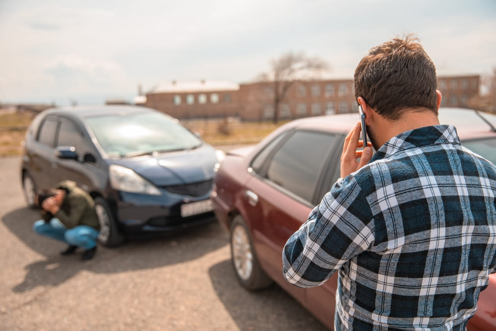 two drivers next to their vehicles after a car accident in texas