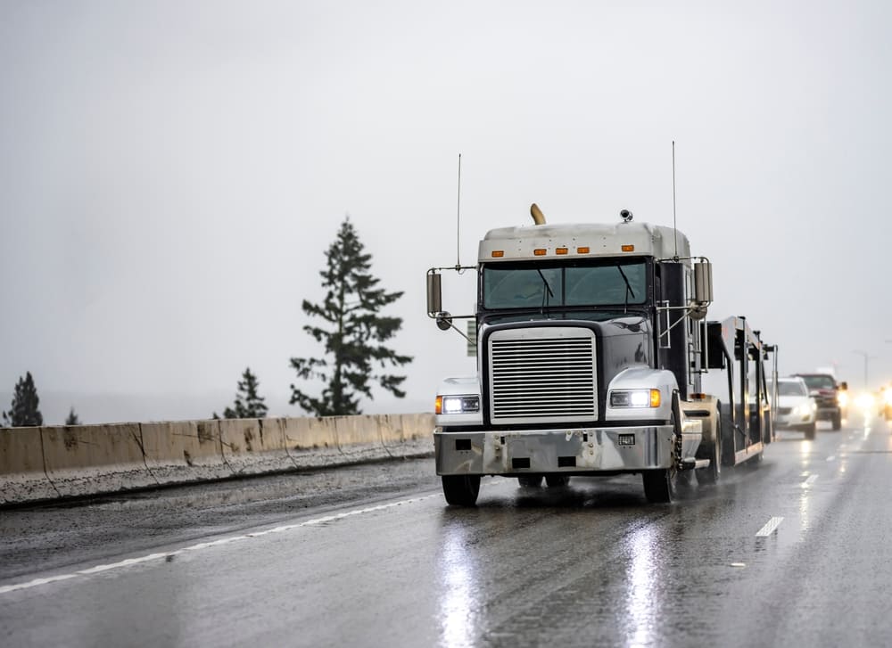 big rig truck driving in bad weather and rain
