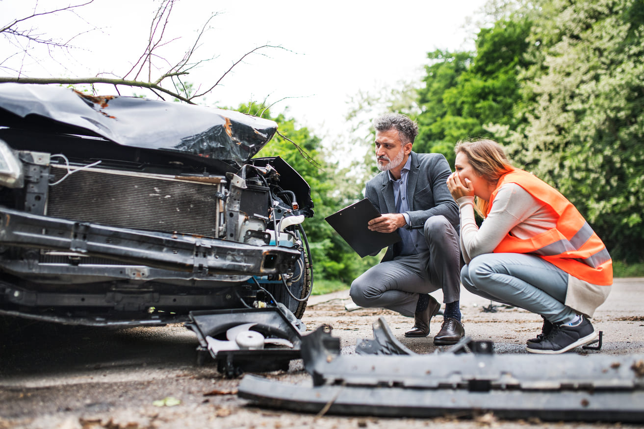 man and woman at scene of car crash no seatbelt